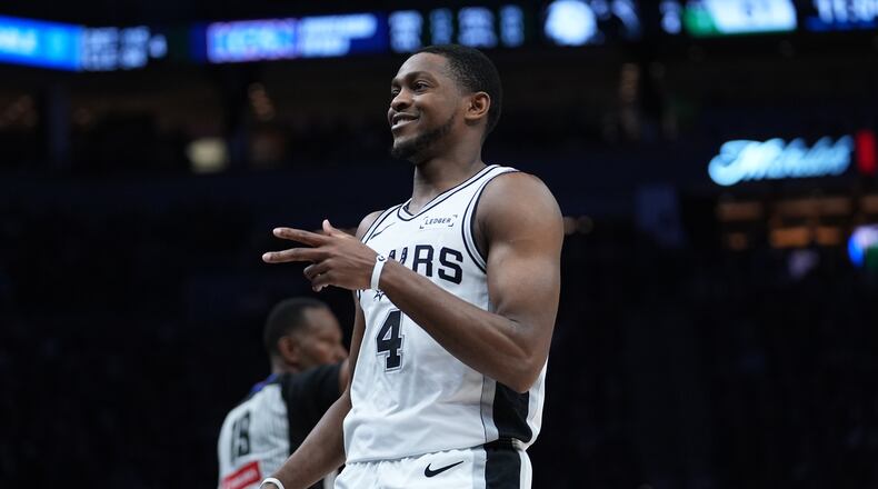 San Antonio Spurs guard De'aaron Fox (4) reacts after scoring against the Minnesota Timberwolves during the second half of Game 6 of an NBA basketball second-round playoffs series in Minneapolis, Friday, May 15, 2026. (AP Photo/Abbie Parr)