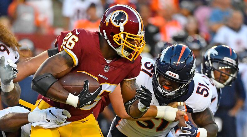 Washington Redskins running back Adrian Peterson (26) carries the ball as Denver Broncos linebacker Todd Davis (51) defends during the first half at FedEx Field.