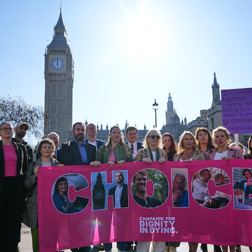 Campaigners hold a banner outside parliament in London as a proposed law to legalise assisted dying in England and Wales will run out of time on Friday, more than a year after MPs first voted in favour of it, Friday, April 24, 2026. (AP Photo/Kirsty Wigglesworth)