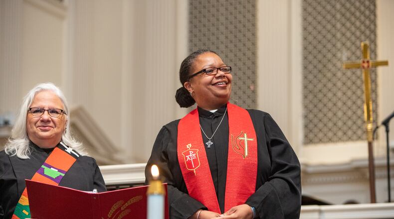 Rev. Dr. Nora Colmenares, left, supports Bishop Robin Dease, right, as Dease is installed as leader of the North Georgia Conference United Methodist Church on Sunday, Jan 8, 2023. (Jenni Girtman for the Atlanta Journal-Constitution)