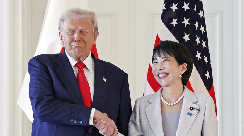 President Donald Trump, left, and Japanese Prime Minister Sanae Takaichi shake hands before their summit talk at Akasaka Palace in Tokyo, Tuesday, Oct. 28, 2025. (Kyodo News via AP)