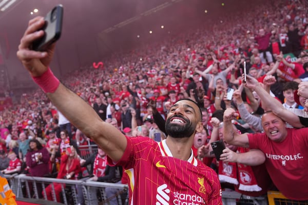 Liverpool's Mohamed Salah celebrates by taking a selfie after winning the English Premier League soccer match between Liverpool and Tottenham Hotspur and clinching the Premier League title at Anfield in Liverpool, England, Sunday, April 27, 2025. (AP Photo/Jon Super)