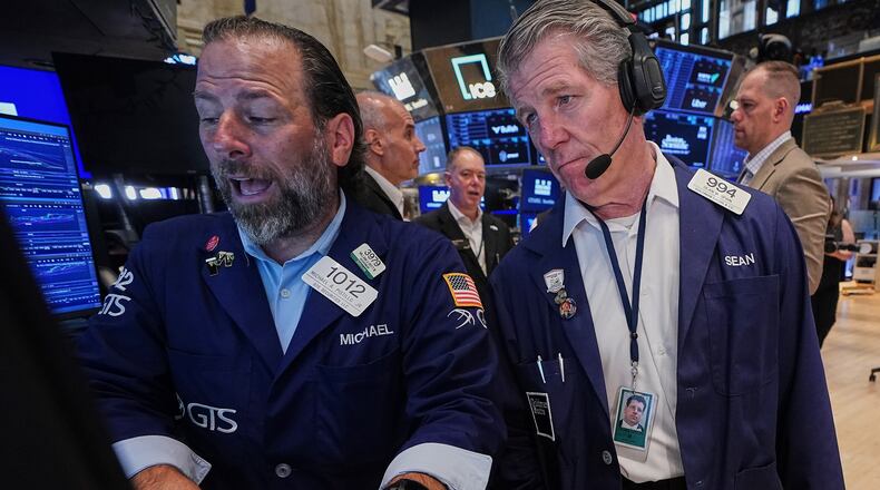 Specialist Michael Pistillo, left, and trader Sean Spain work on the floor of the New York Stock Exchange, Tuesday, June 16, 2026. (AP Photo/Richard Drew)