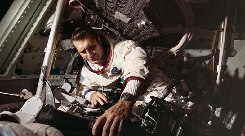 Captain Richard Gordon works on equipment of the Apollo 12 command module, in preparation for the November 14, 1969, mission.