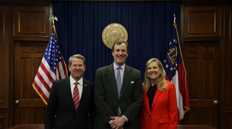 Gov. Brian Kemp and his wife Marty pose for a picture with Trey Kilpatrick, his chief of staff.