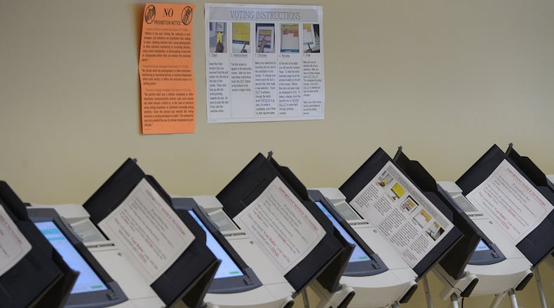 Empty voting machines line the wall inside the Fulton County Government Center in Atlanta on Tuesday, Oct. 22, 2013.