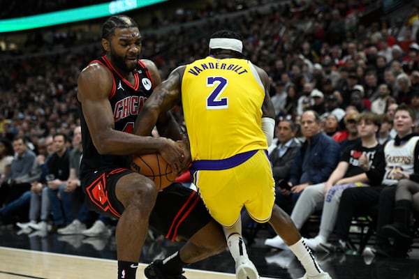 Chicago Bulls' Patrick Williams (44) battles Los Angeles Lakers' Jarred Vanderbilt (2) for a loose ball during the first half of an NBA basketball game Thursday, March 27, 2025, in Chicago. (AP Photo/Paul Beaty)