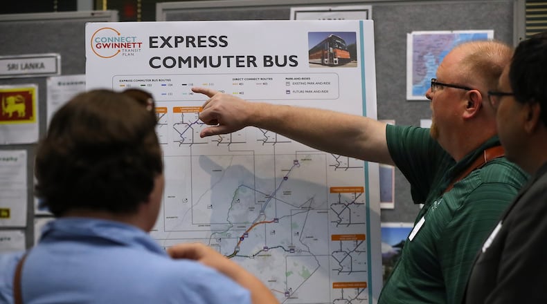 Jessica & Derek Behmke, Lawrenceville, look over one of the displays during a Gwinnett County information session on it’s proposed transit plan at the Gwinnett Justice and Administrative Center oin Lawrenceville. Among other things, the plan calls for a MARTA rail extension to Norcross and new bus rapid transit lines. Curtis Compton/ccompton@ajc.com