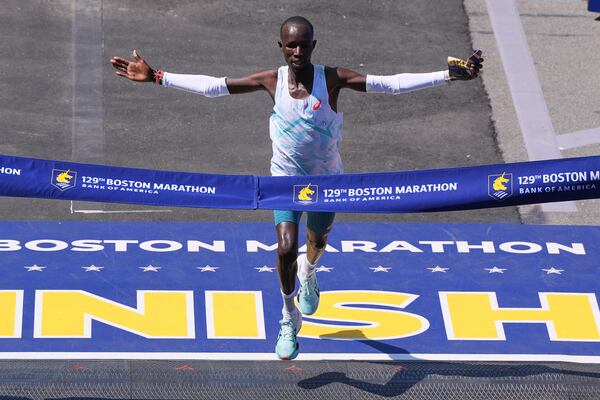 John Korir, of Kenya, breaks the tape to win the Boston Marathon, Monday, April 21, 2025, in Boston. (AP Photo/Charles Krupa)