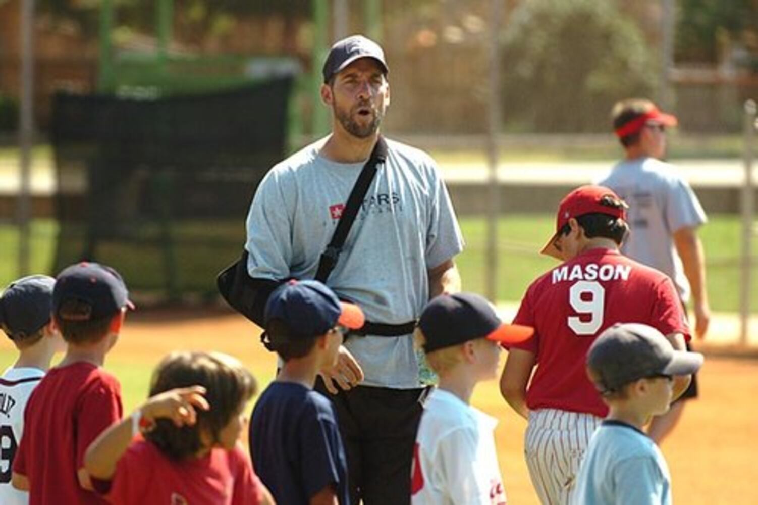 Smoltz coaches young fans at baseball camp