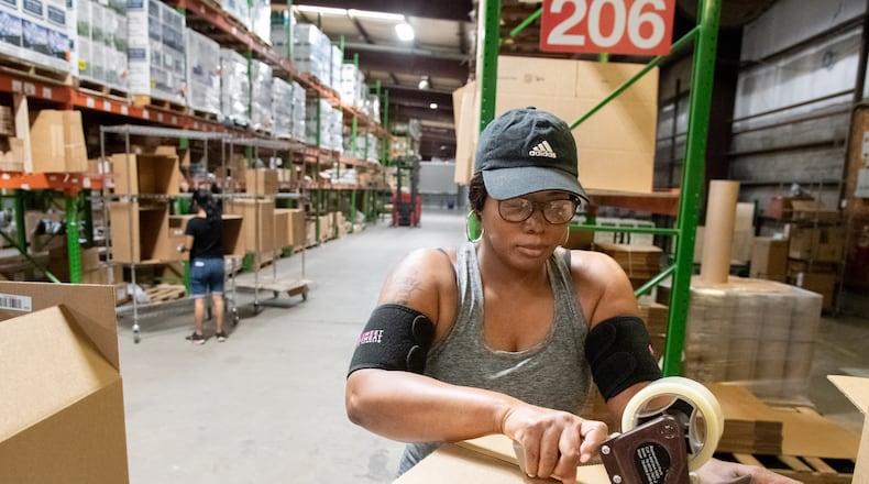 Pro-Built Logistics Warehouse associate Nicole Stewart  boxing e-commerce orders at the Ooltewah, Tenn., location on Sept. 7, 2022. (Photo by Mark Gilliland for The Atlanta Journal-Constitution)