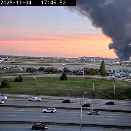 A Kentucky Department of Transportation camera captured a plume of smoke rising above Louisville International Airport in Kentucky on Tuesday, Nov. 4, 2025. UPS Flight 2976 crashed after taking off from Louisville en route to Honolulu, the FAA confirmed. (Screen grab of a Kentucky Department of Transportation traffic camera)