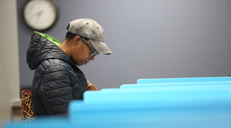 Vallerie Roy of Dekalb County cast her ballot during the first day of early voting at Voter Registration and Elections Office in Atlanta on Monday, March 2, 2020.