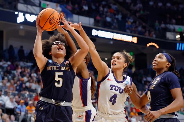 Notre Dame guard Olivia Miles (5) is fouled by TCU guard Donovyn Hunter (4) as she goes up for a shot during the first half in the Sweet 16 of the NCAA college basketball tournament, Saturday, March 29, 2025, in Birmingham, Ala. (AP Photo/Butch Dill)