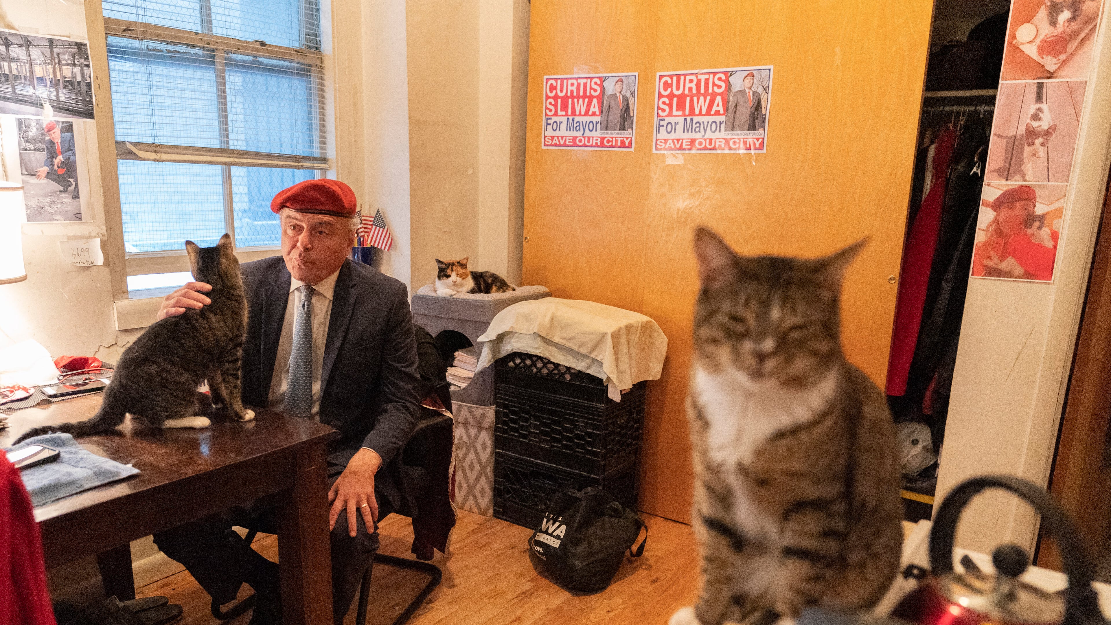 FILE - New York City Republican mayoral candidate Curtis Sliwa pets one of his cats as he speaks during an interview with The Associated Press in his apartment, Tuesday, Oct. 12, 2021, in New York. (AP Photo/Mary Altaffer, file)