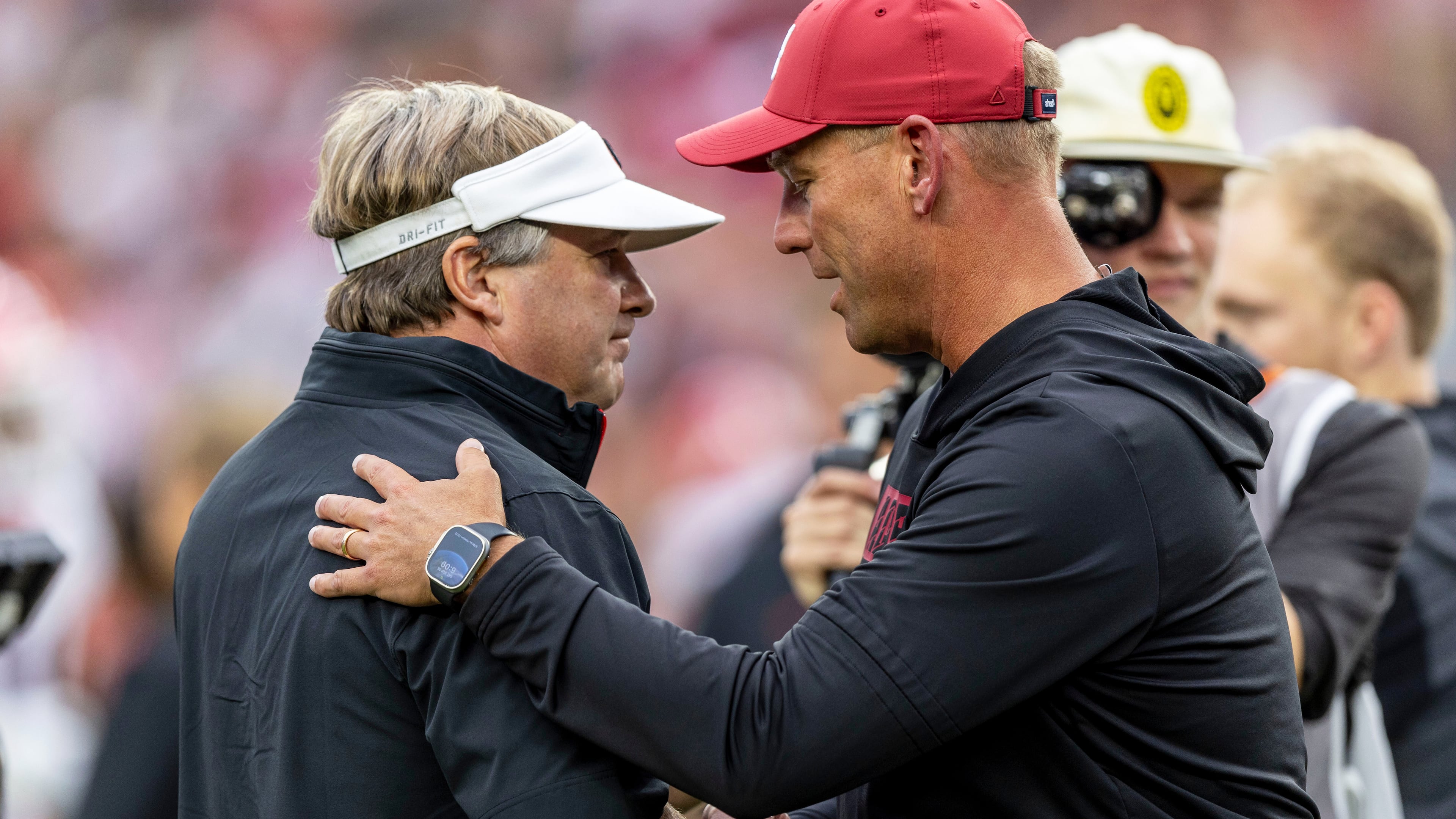 Georgia head coach Kirby Smart, left, and Alabama head coach Kalen DeBoer meet at midfield before an NCAA college football game, Sept. 28, 2024, in Tuscaloosa, Ala. (Vasha Hunt/AP)