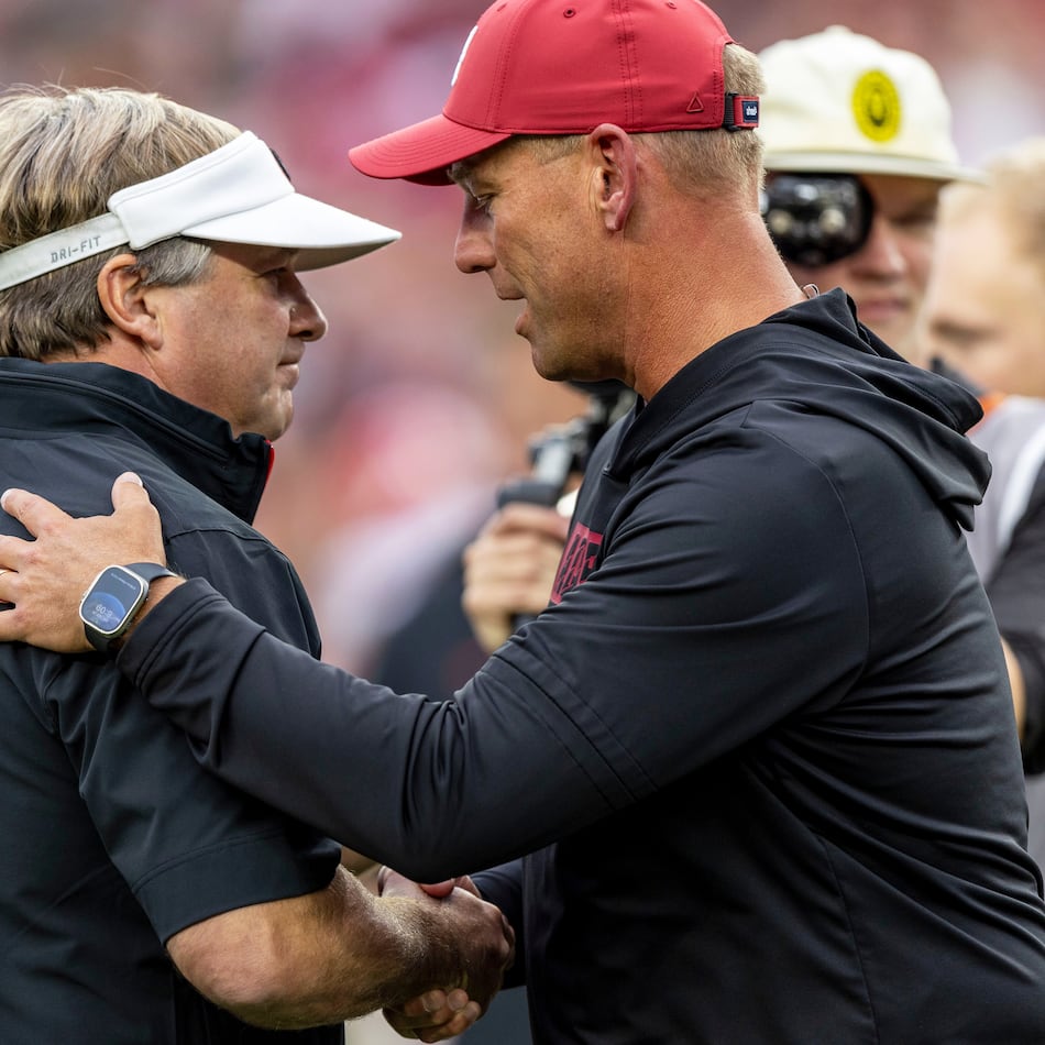 Georgia head coach Kirby Smart, left, and Alabama head coach Kalen DeBoer meet at midfield before an NCAA college football game, Sept. 28, 2024, in Tuscaloosa, Ala. (Vasha Hunt/AP)