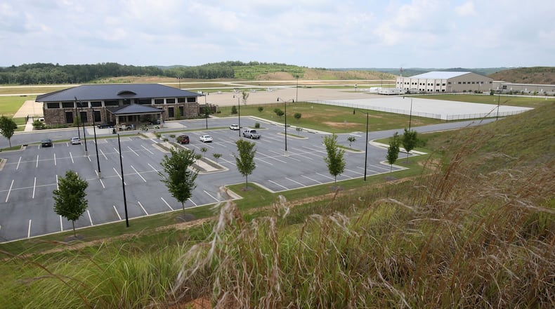 June 25, 2014 - Paulding County - The Paulding County Airport terminal (left) and new hangers (right) viewed from a hill overlooking the airport. Taxi way expansion has been completed, and construction continues in FBO area of Paulding County Airport. First, Delta CEO Richard Anderson said he would fight Paulding County’s effort to commercialize its airport. Then residents filed four legal challenges. Now, the city of Atlanta is threatening legal action, saying Paulding, which purchased land from Atlanta for the airport back in 2007, is in breach of contract on that deal. Paulding officials deny that and say Atlanta’s opposition flies in the face of the regionalism that Mayor Kasim Reed spoke about to leaders there a few years ago. BOB ANDRES / BANDRES@AJC.COM