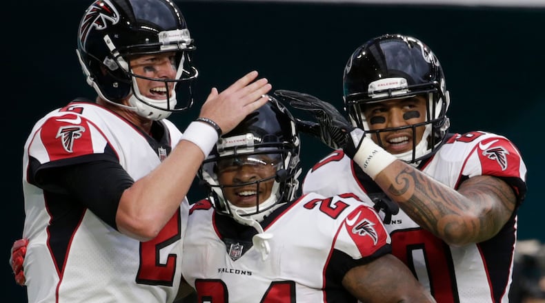 Atlanta Falcons quarterback Matt Ryan (2) and tight end Levine Toilolo (80) congratulate running back Devonta Freeman (24), after Freeman scored at touchdown during the first half against the Miami Dolphins, Thursday, Aug. 10, 2017 in Miami Gardens, Fla.