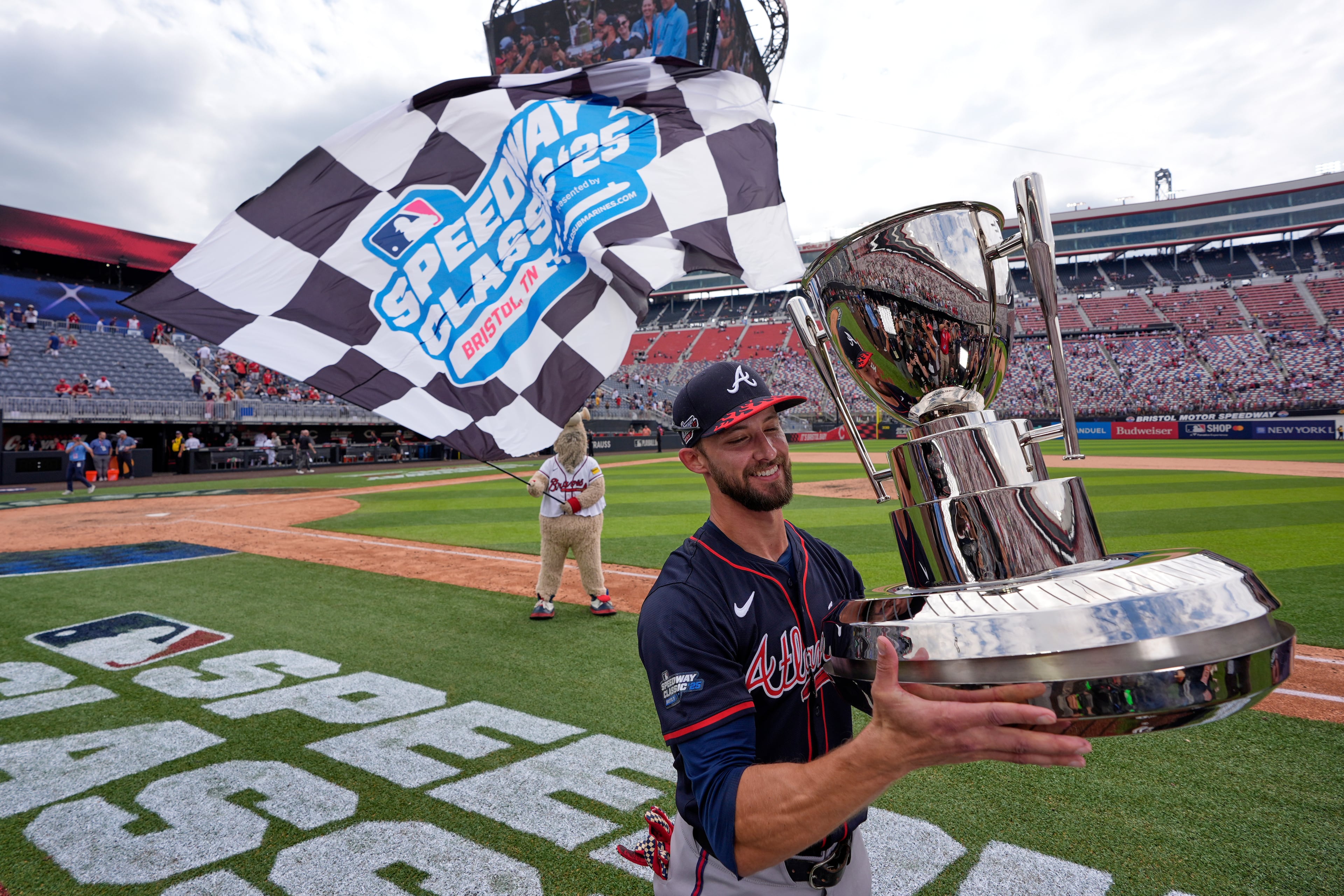Outfielder Eli White holds the hardware after helping fuel a Braves win at Bristol Motor Speedway.