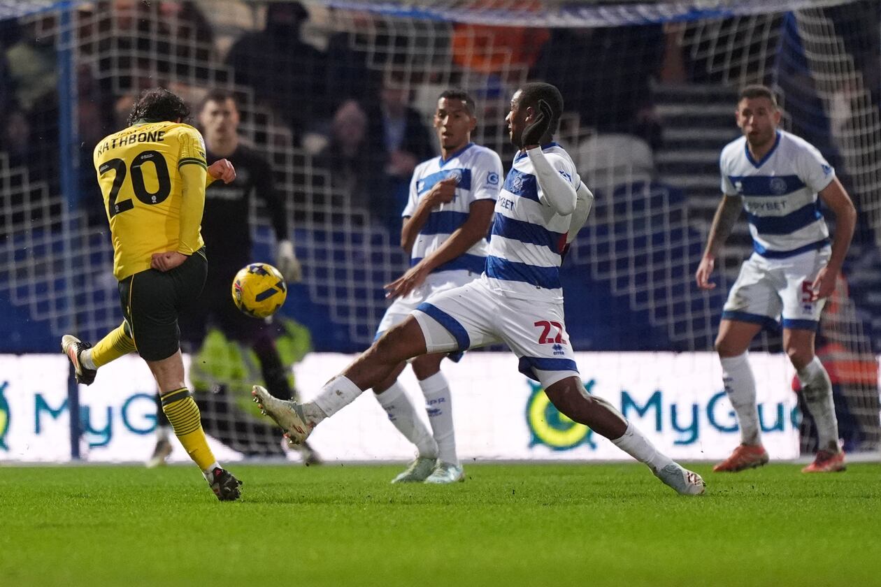 Wrexham's Ollie Rathbone, left, scores their side's third goal of the game during the Sky Bet Championship soccer match between Queens Park Rangers and Wrexham in London, Saturday Jan. 24, 2026. (Ben Whitley/PA via AP)