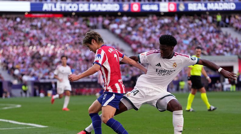 Atletico Madrid's Lee Kang-in tries to dribble the ball past Real Madrid's Aurelien Tchouameni, right, during a Spanish La Liga soccer match between Atletico Madrid and Real Madrid in Madrid, Sunday, Sept. 20, 2026. (AP Photo/Bernat Armangue)