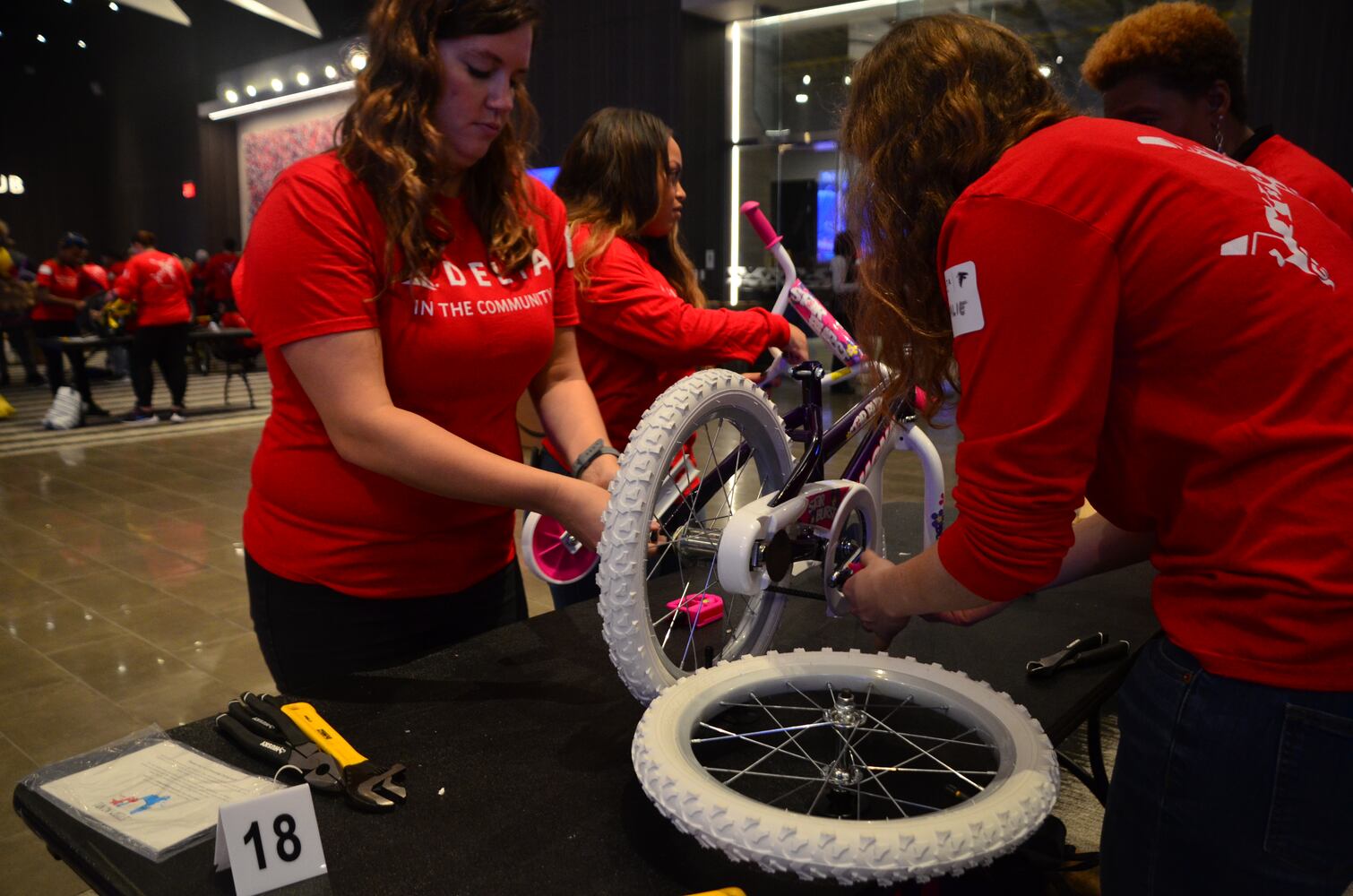 Delta volunteers assemble 100 bicycles to donate to kids