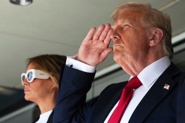 President Donald Trump, right, salutes alonside first lady Melania Trump as they attend the Club World Cup final soccer match, at MetLife Stadium in East Rutherford, N.J., Sunday, July 13, 2025. (AP Photo/Jacquelyn Martin)