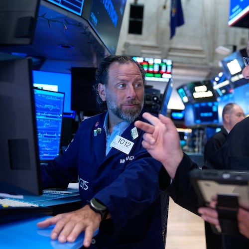 Michael Pistillo, left, and Federico DeMarco work on the floor at the New York Stock Exchange in New York, Monday, July 6, 2026. (AP Photo/Seth Wenig)