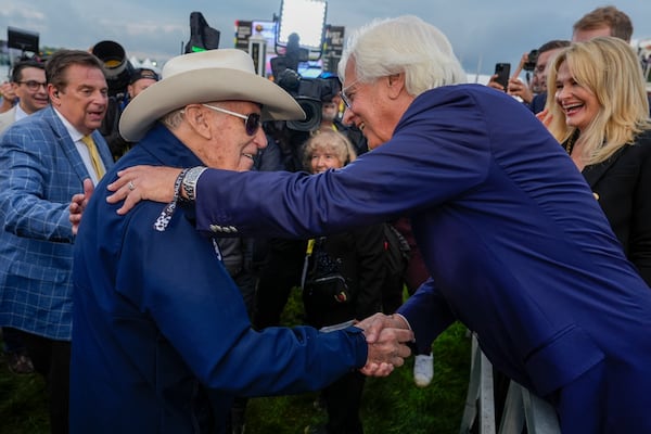 FILE - Seize The Grey's trainer D. Wayne Lukas, left, shakes hands with with Bob Baffert, Imagination's trainer, after Lukas' horse won the Preakness Stakes horse race at Pimlico Race Course, May 18, 2024, in Baltimore. (AP Photo/Julia Nikhinson, file)