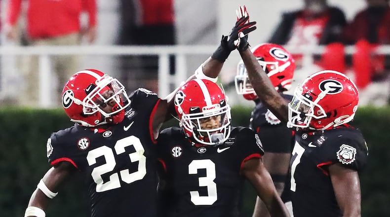 Georgia defensive backs Mark Webb (from left), Tyson Campbell, and Tyrique Stevenson celebrate stopping Mississippi State during the second half Saturday, Nov. 21, 2020, in Athens. (Curtis Compton / Curtis.Compton@ajc.com)