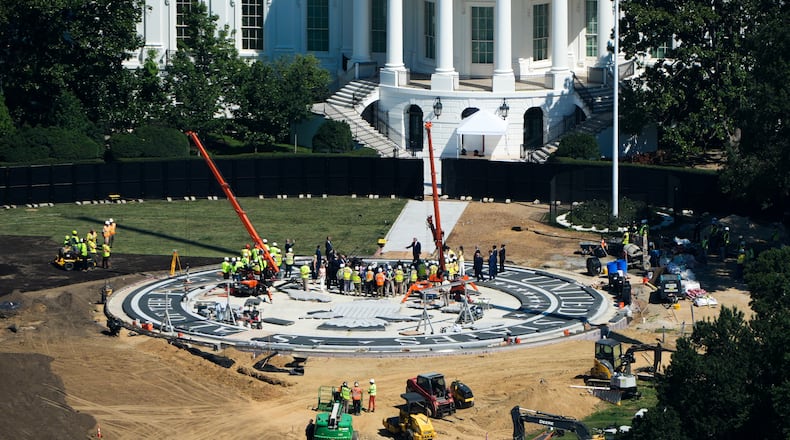 President Donald Trump speaks on the South Lawn of the White House at the construction site of the new helicopter landing zone, Wednesday, Aug. 19, 2026, seen from the Washington Monument in Washington. (AP Photo/Alex Brandon)