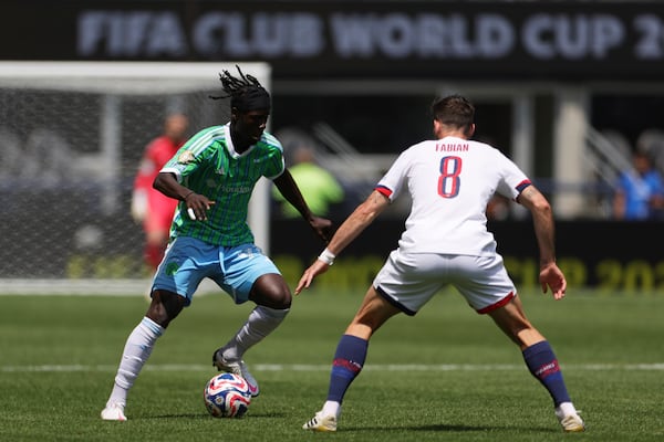 Seattle Sounders' Georgi Minoungou, left, controls the ball as Paris Saint-Germain's Fabian Ruiz defends during the Club World Cup Group B soccer match between Seattle Sounders and PSG in Seattle, Monday, June 23, 2025. (AP Photo/Ryan Sun)
