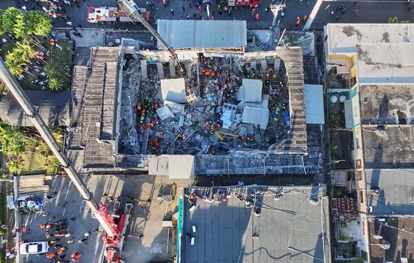 Rescue workers search for survivors at the Jet Set nightclub after its roof collapsed during a merengue concert in Santo Domingo, Dominican Republic, Tuesday, April 8, 2025.(Noticias SIN via AP)