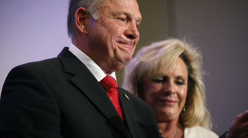 U.S. Senate candidate Roy Moore, a former chief justice of Alabama’s Supreme Court, speaks at a news conference Thursday in Birmingham, Ala., with his wife, Kayla Moore, at his side. (AP Photo/Brynn Anderson)