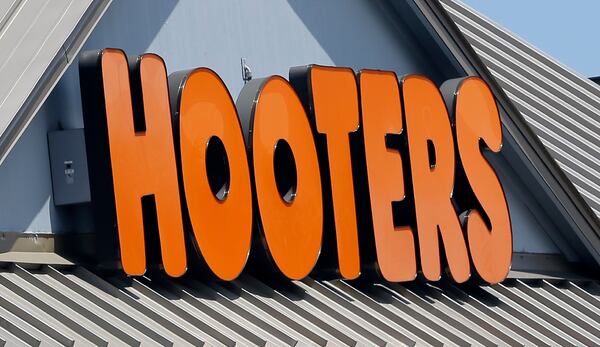 FILE- July 27, 2017, shows a Hooters sign at a restaurant in Hialeah, Fla. (AP Photo/Alan Diaz, File)
