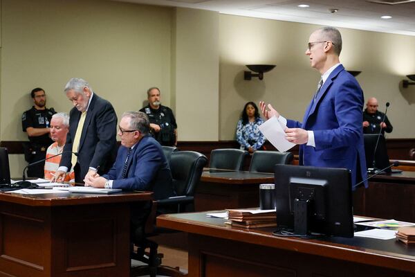 District Attorney Brad Smith (right) speaks with Barrow County Superior Court Judge Nicholas Primm during the hearing regarding whether the trial against Colin Gray, the father of Apalachee High School shooting suspect Colt Gray, will be moved out of Barrow County (Miguel Martinez/AJC)