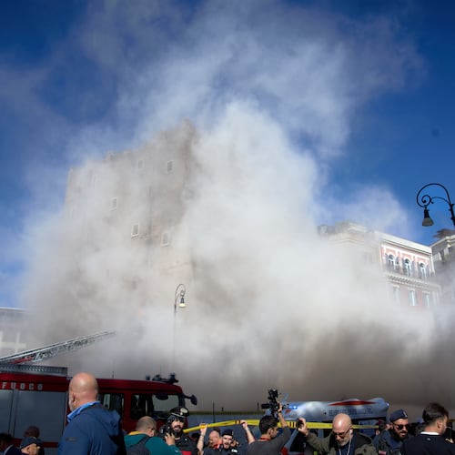 The medieval tower Torre dei Conti near the Roman Forum is engulfed by a cloud of debris from a second collapse after it had partially collapsed during renovation works, in Rome, Italy, Monday, Nov. 3, 2025. (AP Photo/Domenico Stinellis)