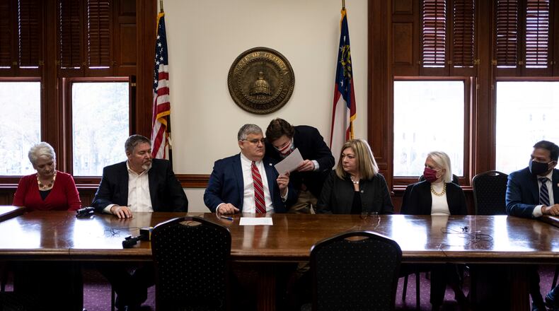 An alternate slate of electors nominated by the Republican Party of Georgia, declaring themselves the "duly elected" slate, cast 16 electoral votes for then-President Donald Trump and then-Vice President Mike Pence at the Georgia Capitol on Dec. 14, 2020. At the same time, the official Democratic electors were in another part of the Capitol, casting their votes for Joe Biden following his narrow victory in Georgia. (AP Photo/Ben Gray)
