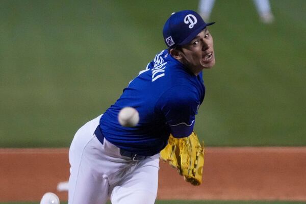 Los Angeles Dodgers pitcher Roki Sasaki (11) throws during the sixth inning of a spring training baseball game against the Cincinnati Reds, Tuesday, March. 4, 2025, in Phoenix. (AP Photo/Darryl Webb)