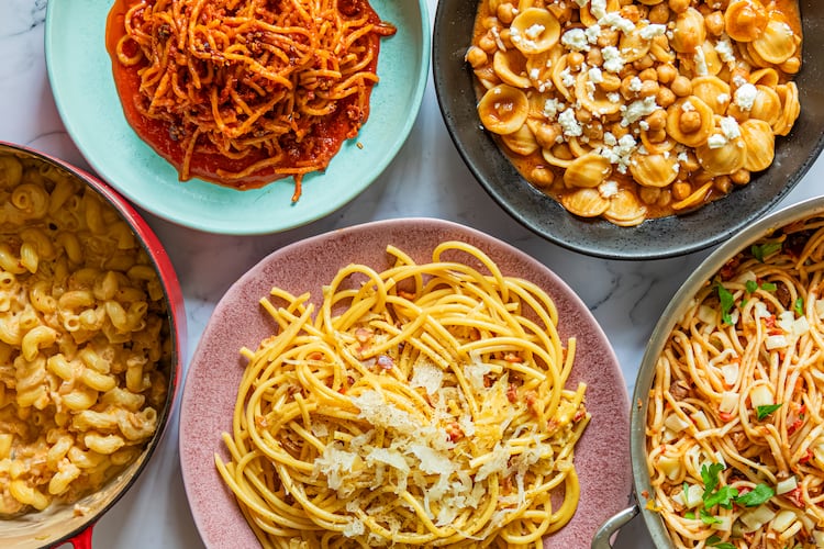 Get a tasty pasta dinner on the table using ingredients you already have at home. Clockwise from top left: Chili Crisp Assassin's Spaghetti, Tagine-Inspired Pasta e Ceci, Muffuletta Pasta, German-Inspired Carbonara and Miso-Kimchi Macaroni and Cheese. (Aaliyah Man for the AJC)