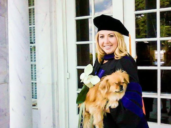 Lauren Giddings with her dog, Butterbean, at her graduation from Mercer University's law school in 2011. Giddings, 27, was murdered a month later. (Contributed photo)
