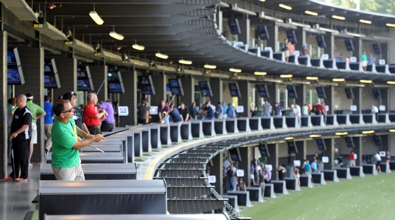 Customers at hitting bays at TopGolf Alpharetta in this AJC file photo.