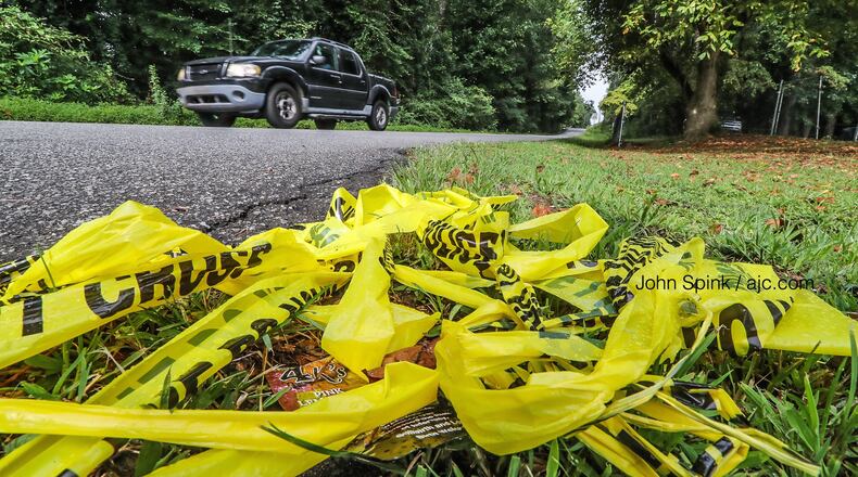 Crime scene tape remains on Crystal Lake Road at Warrington Place, where a teenager was found shot and killed Thursday night.