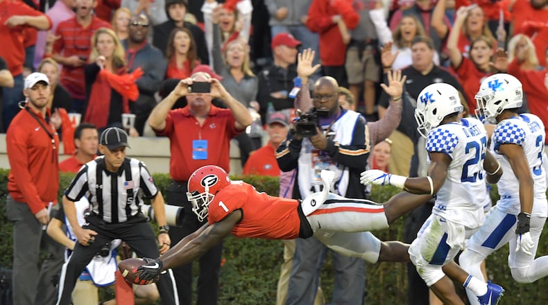 Georgia running back Sony Michel (1) dives into the endzone for a touchdown during Saturday's game against Kentucky. Hyosub Shin/hshin@ajc.com
