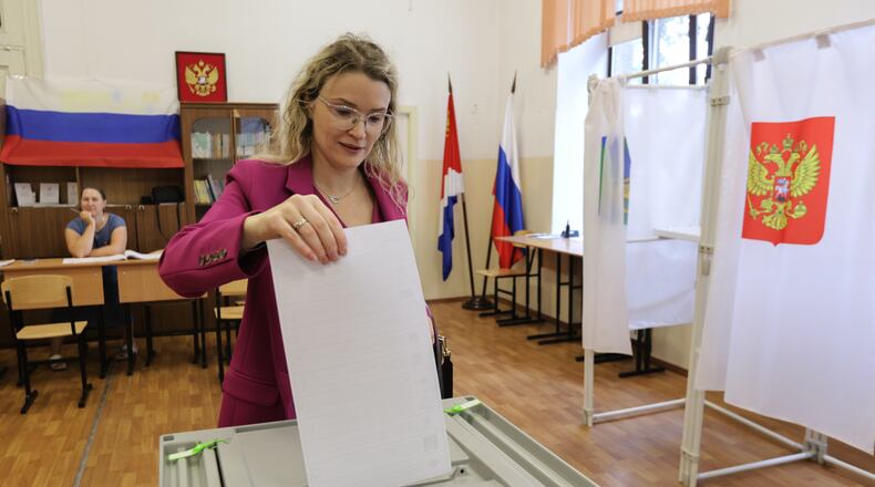 A woman casts her ballot in the parliamentary election in Vladivostok, Russia, Friday, Sept. 18, 2026. (AP Photo)