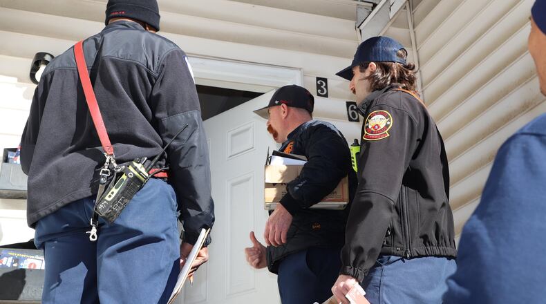 Firefighters went door-to-door Friday installing smoke detectors in an Atlanta neighborhood after a blaze killed two people Wednesday morning.