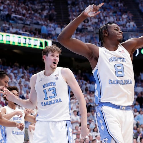 North Carolina center Henri Veesaar (13) and forward Caleb Wilson (8) celebrate a turnover by Kansas during the second half of an NCAA college basketball game Friday, Nov. 7, 2025, in Chapel Hill, N.C. (AP Photo/Chris Seward)