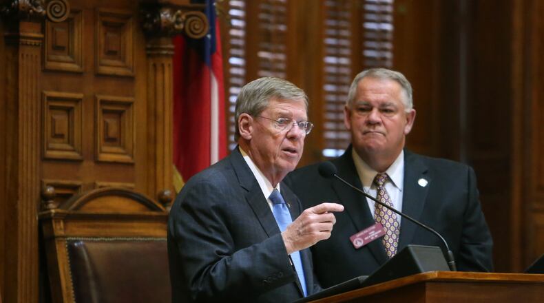 Then-U.S. Senator Johnny Isakson speaks to the House next to House Speaker David Ralston, right, in 2013. Senator Isakson is a former member of the House. JASON GETZ / JGETZ@AJC.COM