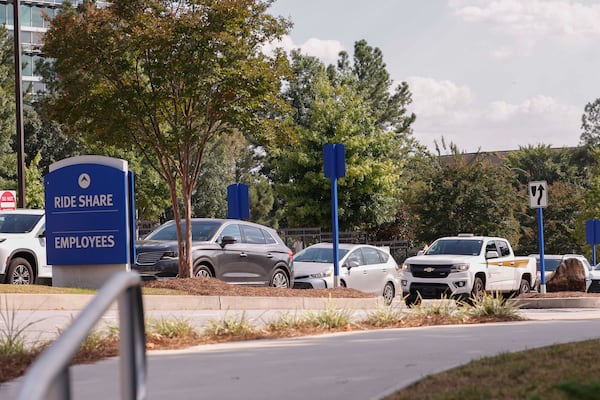 A line of cars leaving the Centers for Disease Control and Prevention in Atlanta on Monday. (Natrice Miller/AJC)